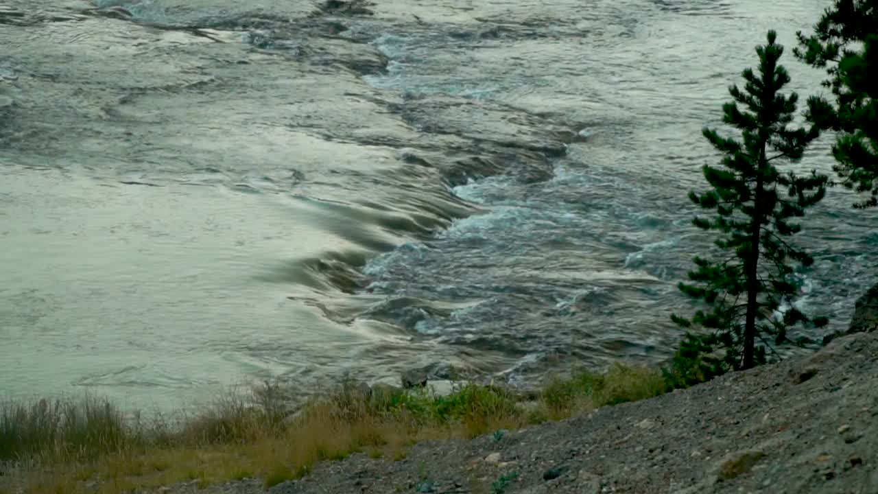Beautiful swiftly flowing river cascading over submerged rocks