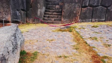 tilt up reveal shot of famous stairway at sacsayhuamán archaeological site in cusco, peru