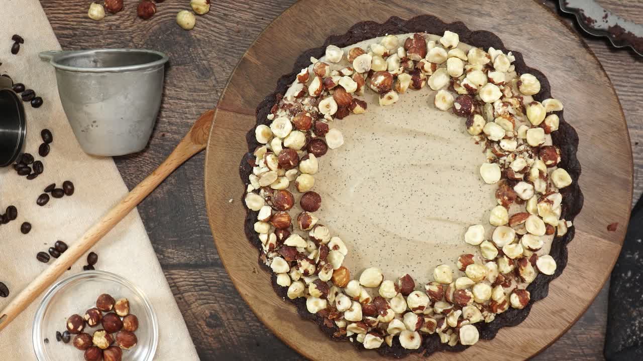 A delicious dessert, Coffee Hazelnut Cream Tart. Made with espresso powder, chocolate crust and loaded with crushed hazelnut. Adding hazelnuts to the top of the chocolate espresso cake and a garnish