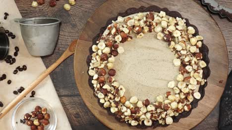 a delicious dessert, coffee hazelnut cream tart. made with espresso powder, chocolate crust and loaded with crushed hazelnut. adding hazelnuts to the top of the chocolate espresso cake and a garnish