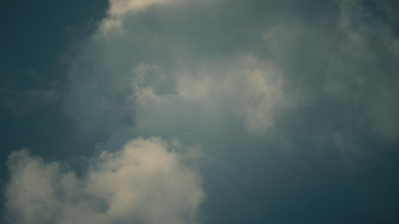 A smooth time lapse of a colorful surfing clouds, blue skies, 6K resolution video
