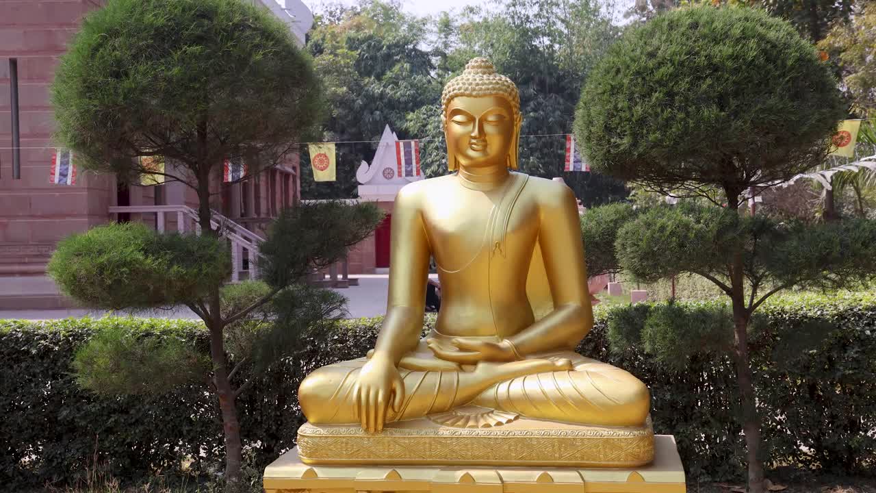 golden buddha idol sitting in peaceful lotus position at outdoor