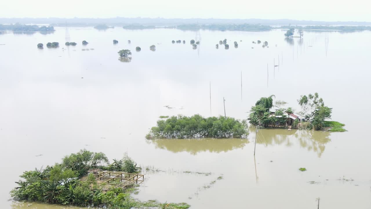 Rural village houses submerged in flood water at a haor area in Bangladesh. Aerial shot