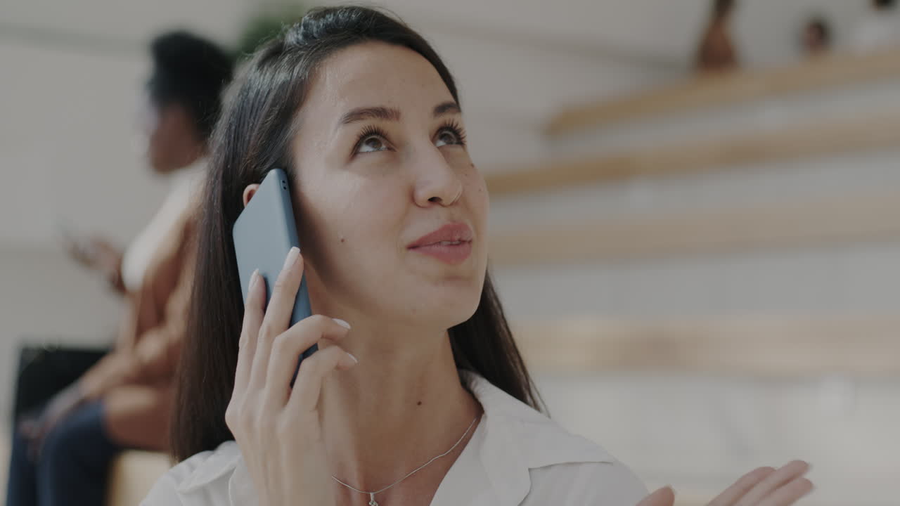Woman Talking on Phone in a Modern Office