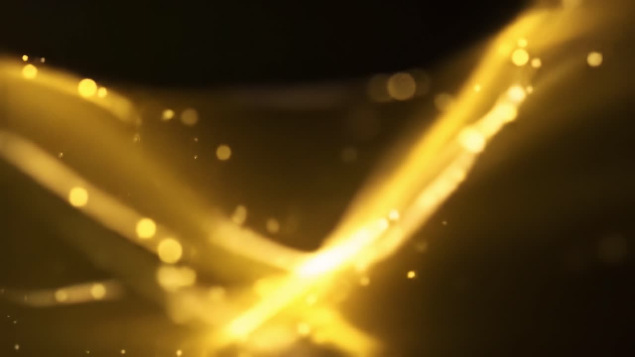 Golden light flows seamlessly, creating a captivating visual experience. The shimmering waves fluctuate and transform, showcasing their vibrant brilliance in a dark background.