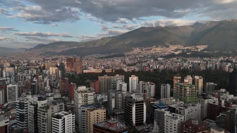 Aerial-drone-video-view-footage-of-Qutio-early-morning-sunrise-capital-city-of-Ecuador-La-Carolina-Park-traffic-Catedral-Metropolitana-de-Quito-south-american-skyline