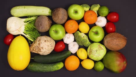 fresh ripe and healthy fruits and vegetables appear on black table. stop motion