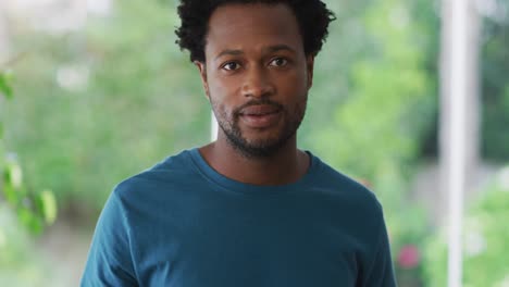 Portrait-of-biracial-man-looking-at-camera-and-smiling