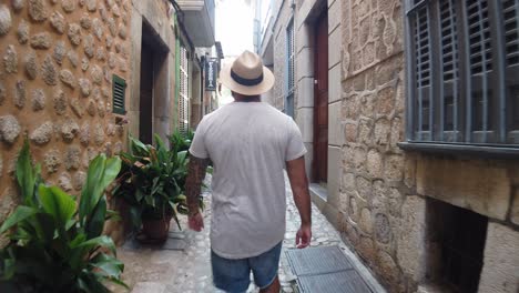 man walking down a street in soller