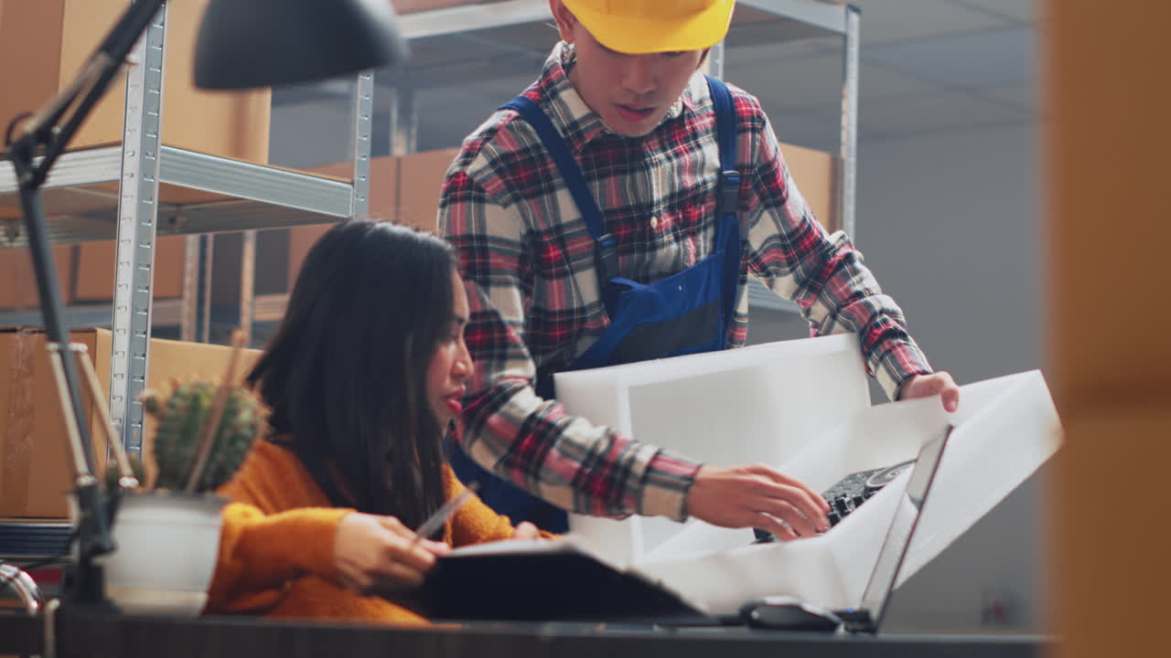 Warehouse employees working together on packaging