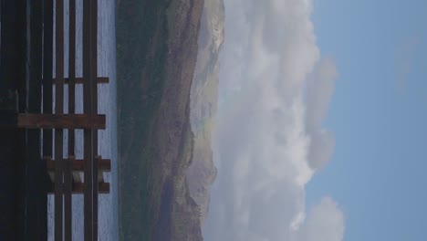 mountains and lake with white clouds in patagonia, argentina