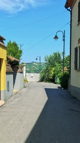 sunny alleyway with yellow buildings and greenery
