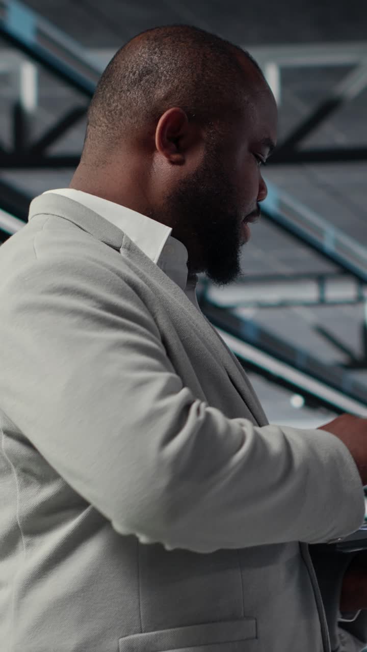 Vertical video Admin walking in data center industrial platform, analyzing performance