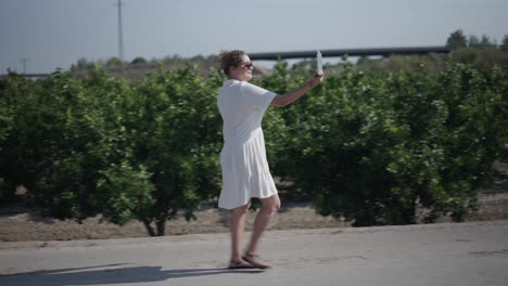 woman walking with tablet in a field