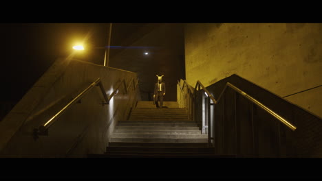 man walking down the stairs with a rabbit head carries a briefcase