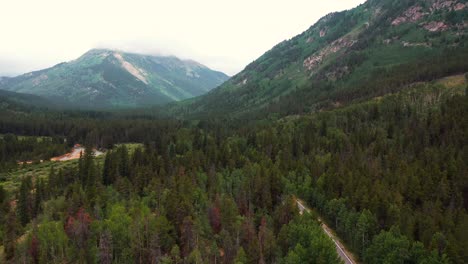 panning shot of vehicles traveling through scenic and moody independence pass rocky mountain colorado roads