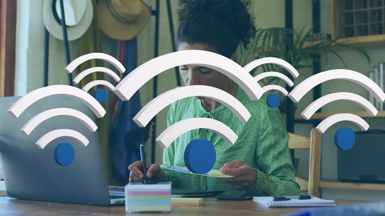 Woman starting writing papers in home office Wi?Fi overlays growing over laptop showing remote work