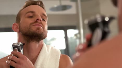 handsome man trimming his beard