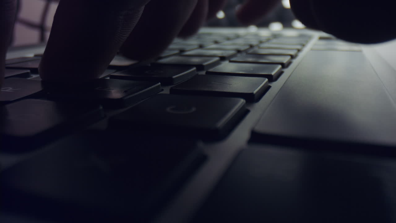 Man hands typing on laptop keyboard. Male person working on grey laptop computer