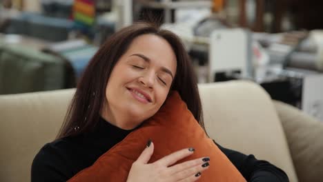 a young woman in the store chooses a pillow for a good nights sleep a young woman in the store chooses a pillow for a good nights sleep