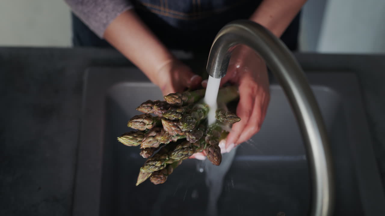 Woman washes ingredients for salad 7