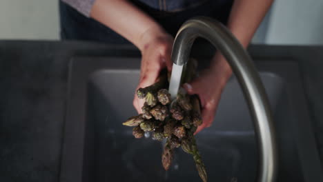 woman washes ingredients for salad 7