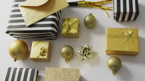 Baubles-and-presents-on-white-background-at-new-year's-eve