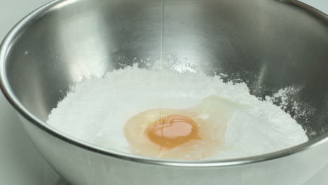 adding egg on flour