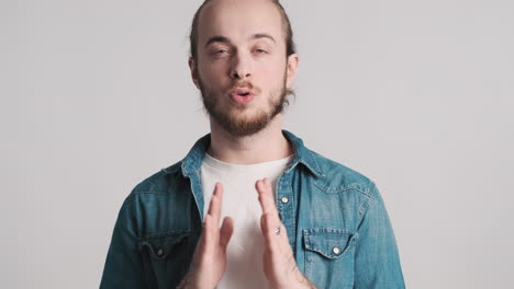 caucasian young man doing breathing exercises on camera.