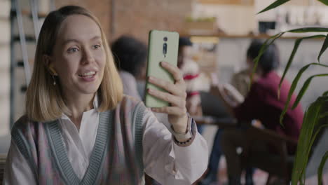 woman on video call in cafe