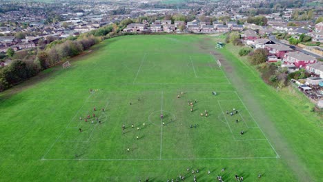 aerial drone video of extensive playing fields situated on the summit of a hill