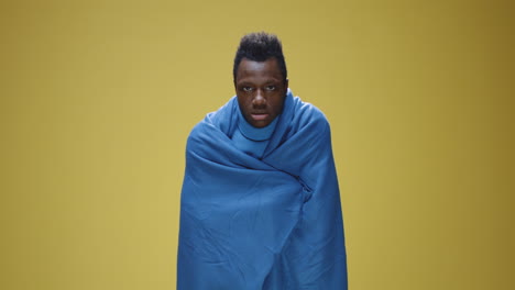man wrapped in blanket