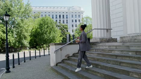 woman walking down stairs in city