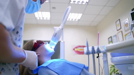 dental procedure in clinic. female patient in dentistry chair in stomatology clinic
