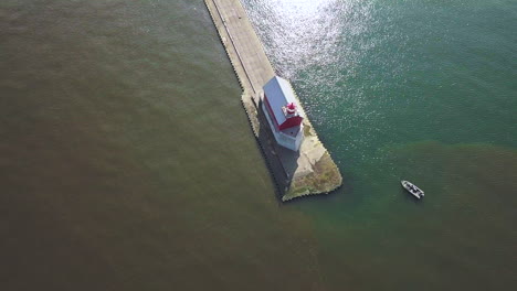 Aerial-view-of-lighthouse-beacon-on-pier-in-Michigan,-USA