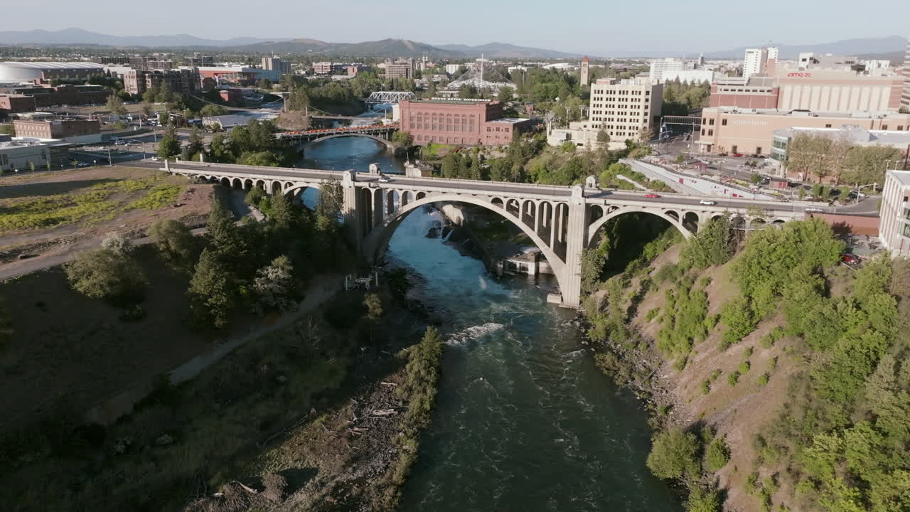 Aerial shot of downtown Spokane featuring the Monroe Street Bridge crossing the river below the city skyline