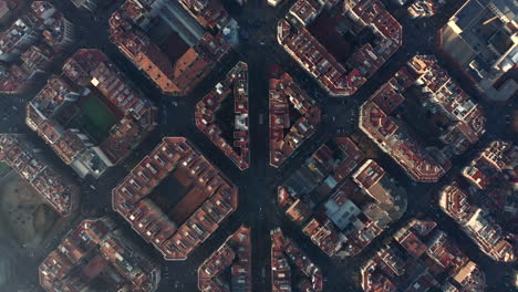 Top-down-footage-of-symmetrical-town-development.-Fly-above-blocks-of-buildings-in-urban-borough.-Barcelona,-Spain