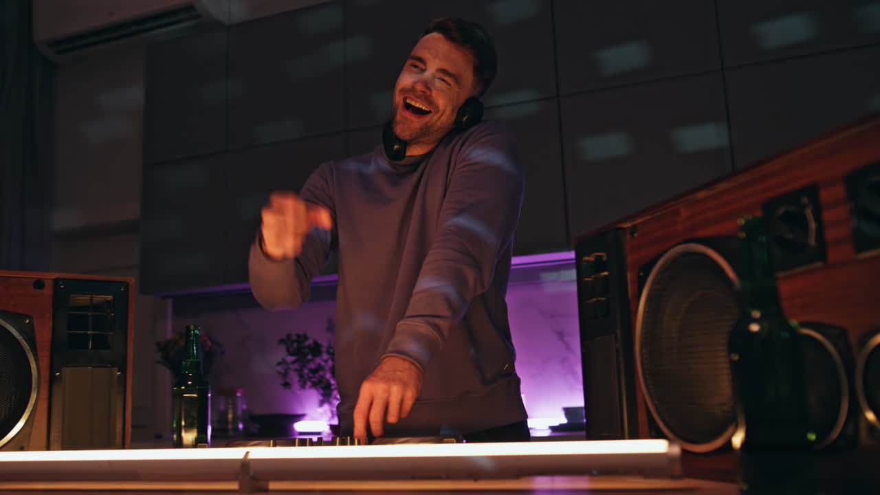 Joyful dj enjoy party mixing music on equipment close up. Man dancing nightclub