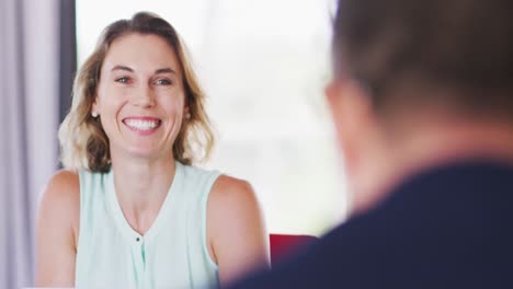 professional businesswoman smiling while talking to her colleagues in modern office in slow motion