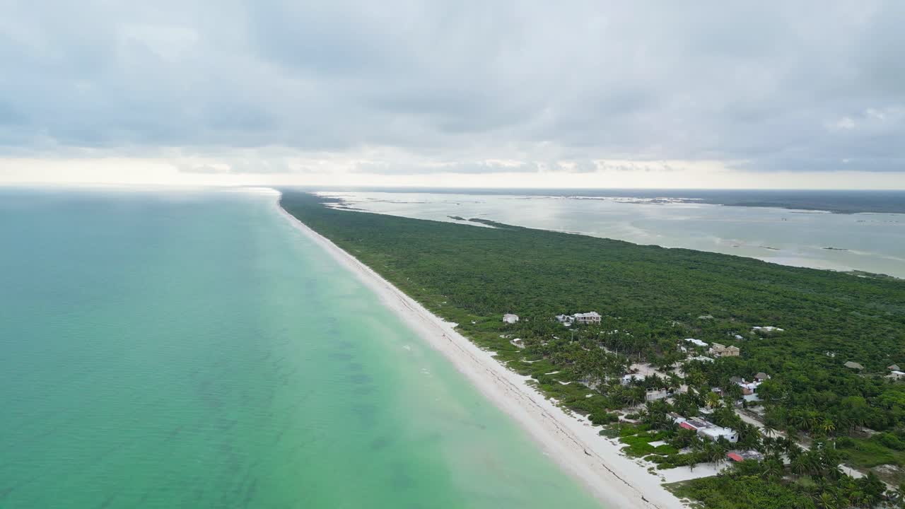A tropical beach in cuyo, mexico, with turquoise water and lush greenery, aerial view