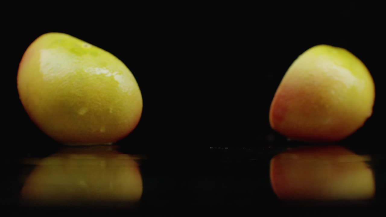 Slow motion. juicy grapefruit with drops and breaks into 2 parts with spray
