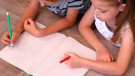 sibling drawing together in living room