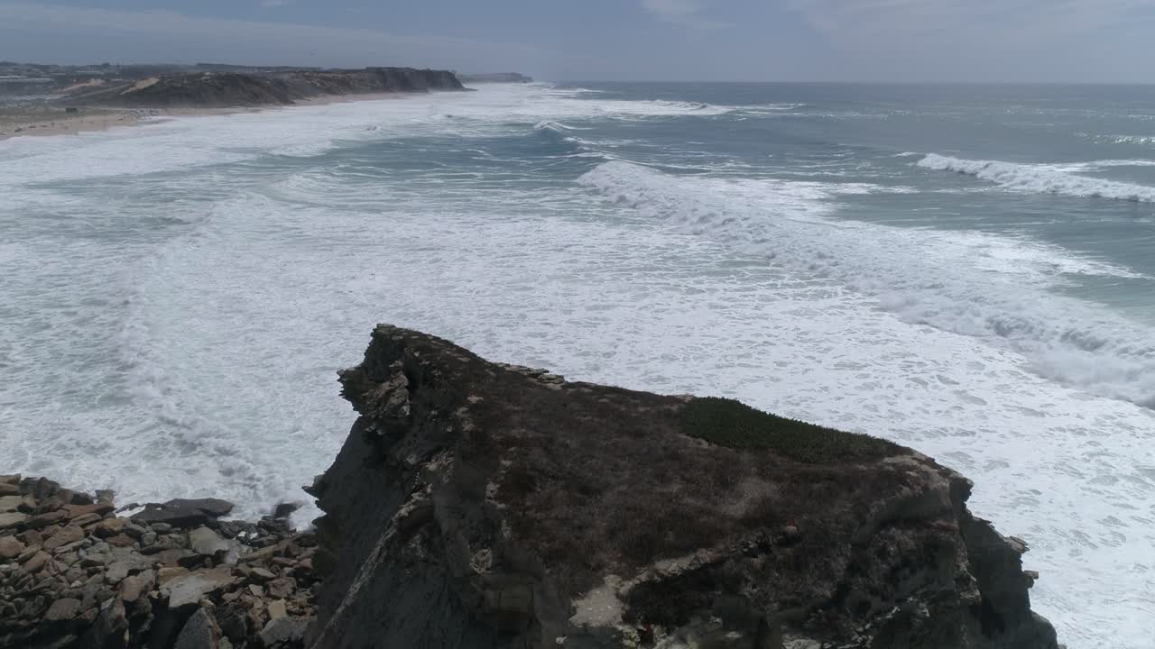 Large rock in the blue sea on a sunny day
