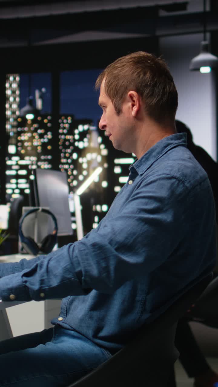 Vertical Video Portrait of male specialist in office uses CAD software and blueprints plan