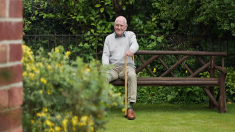 elderly man relaxing on a bench in a garden