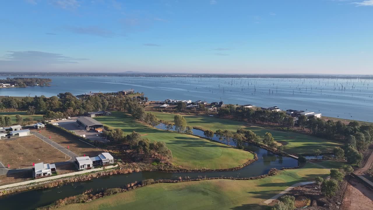 Golf course and homes meet the lakefront in early light near Yarrawonga township