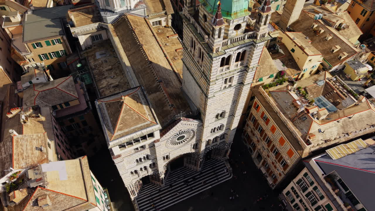 Drone advancing toward San Lorenzo Cathedral in Genoa, performing a tilt down to the parvis on a sunny day
