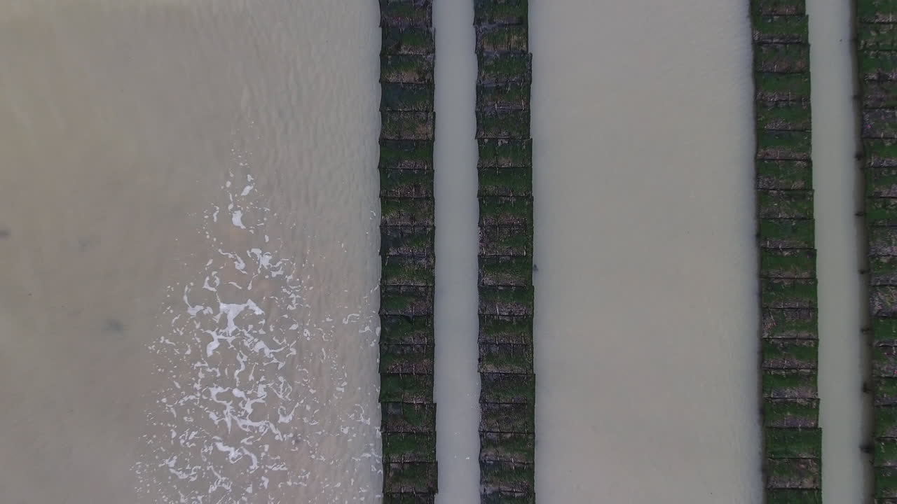 aerial drone vertical view of oyster cages in the sea Normandy D-day beaches