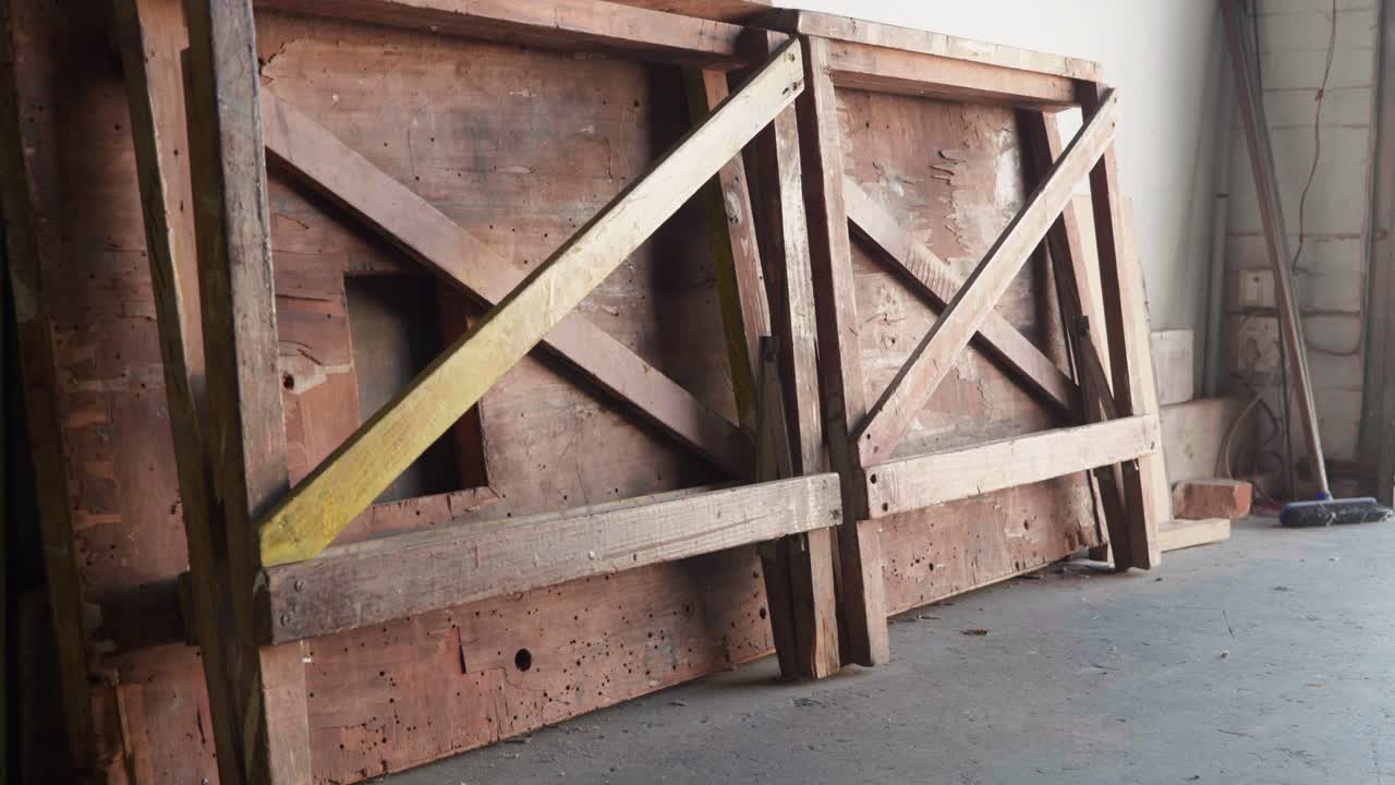 Trestle table and legs resting against wall  in Workshop