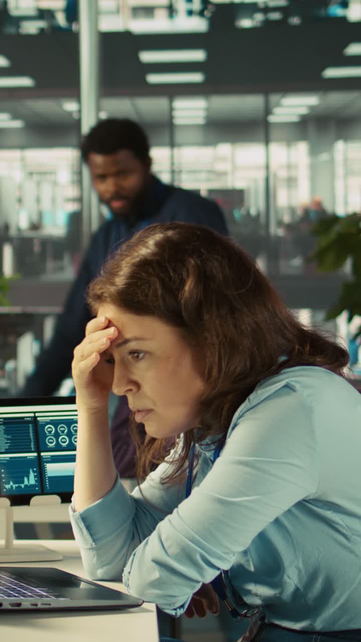 Vertical video Accountant in busy modern startup agency imputing financial figures on PC